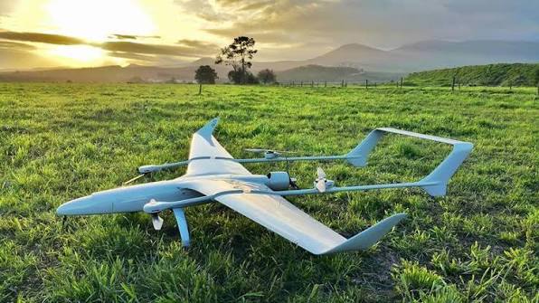 Long-endurance fixed-wing VTOL drone in a field
